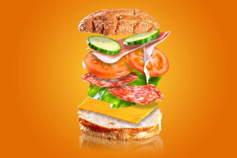 Flying tasty sandwich. Sandwich with flying ingredients isolated